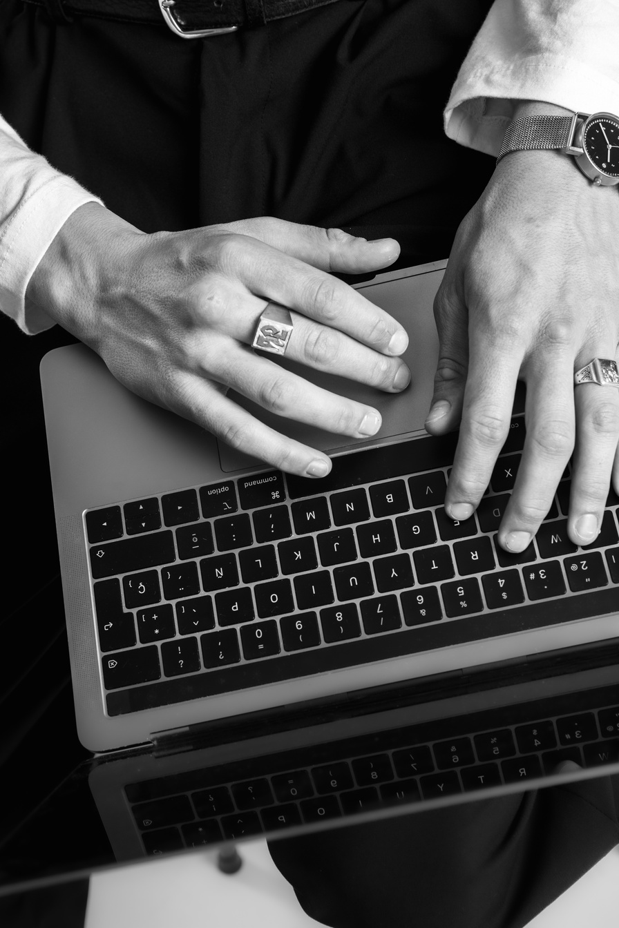 Person's Hands Typing on Laptop Keyboard