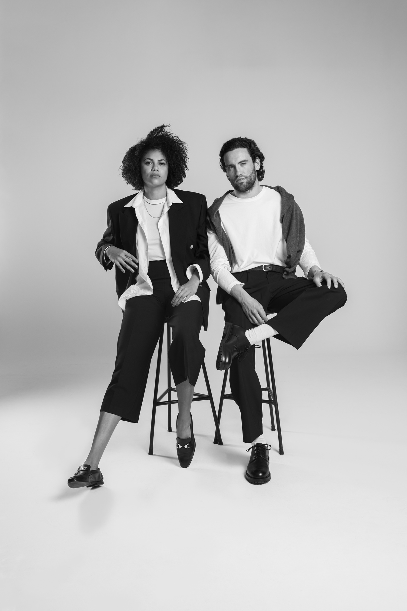 Stylish Man and Woman Sitting on Chairs