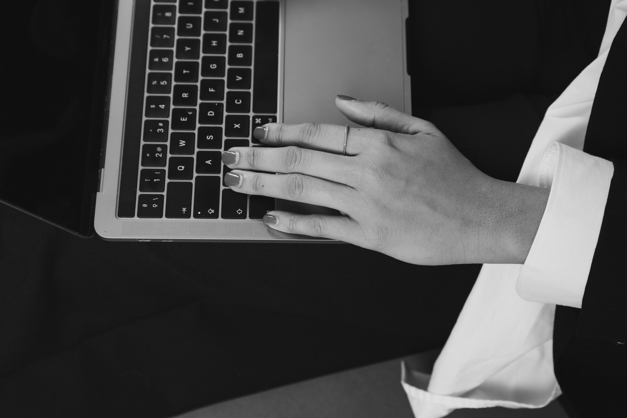 Woman's Hand Typing on a Laptop