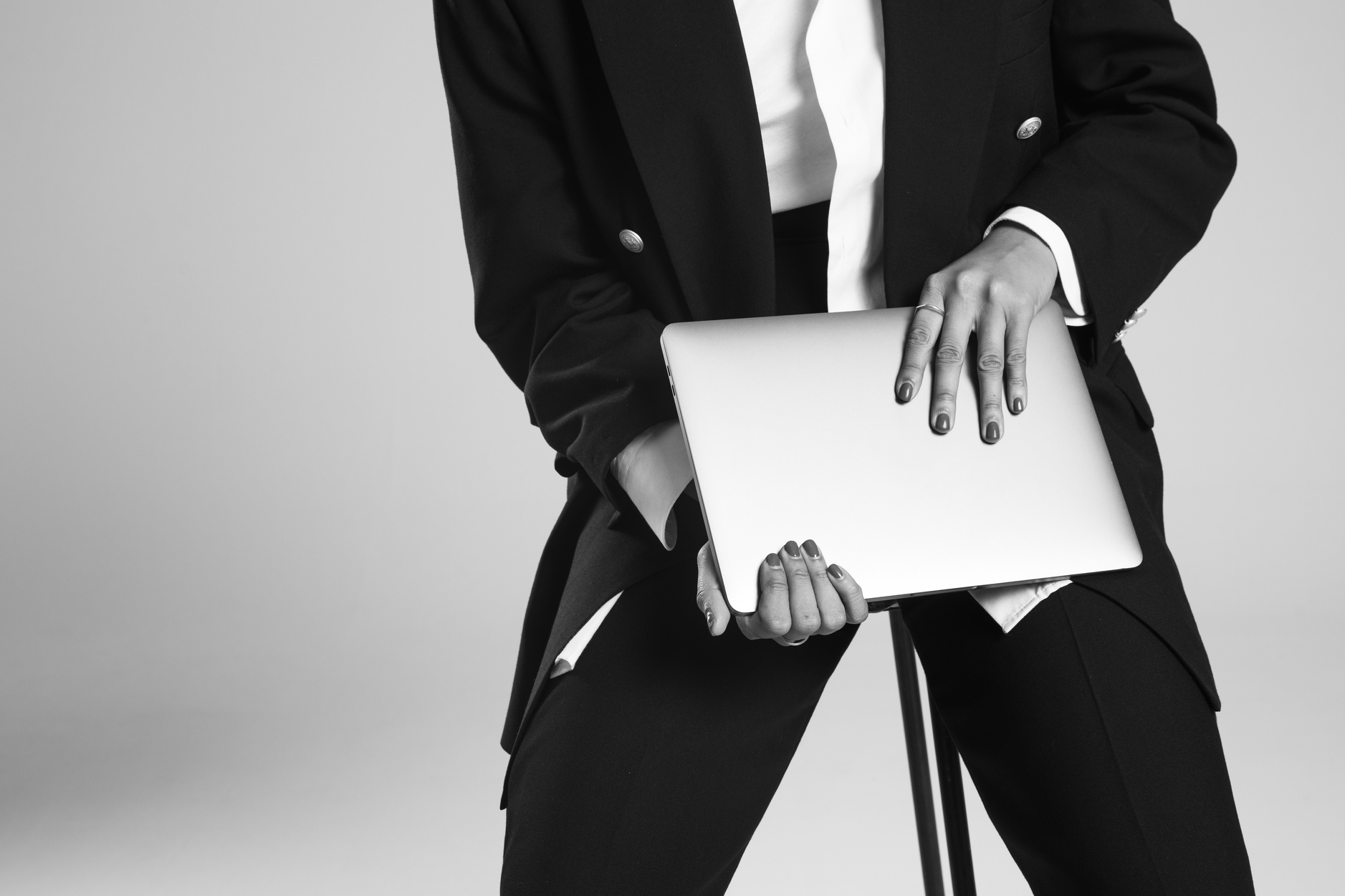 Stylish Woman Sitting on a Chair Carrying a Laptop