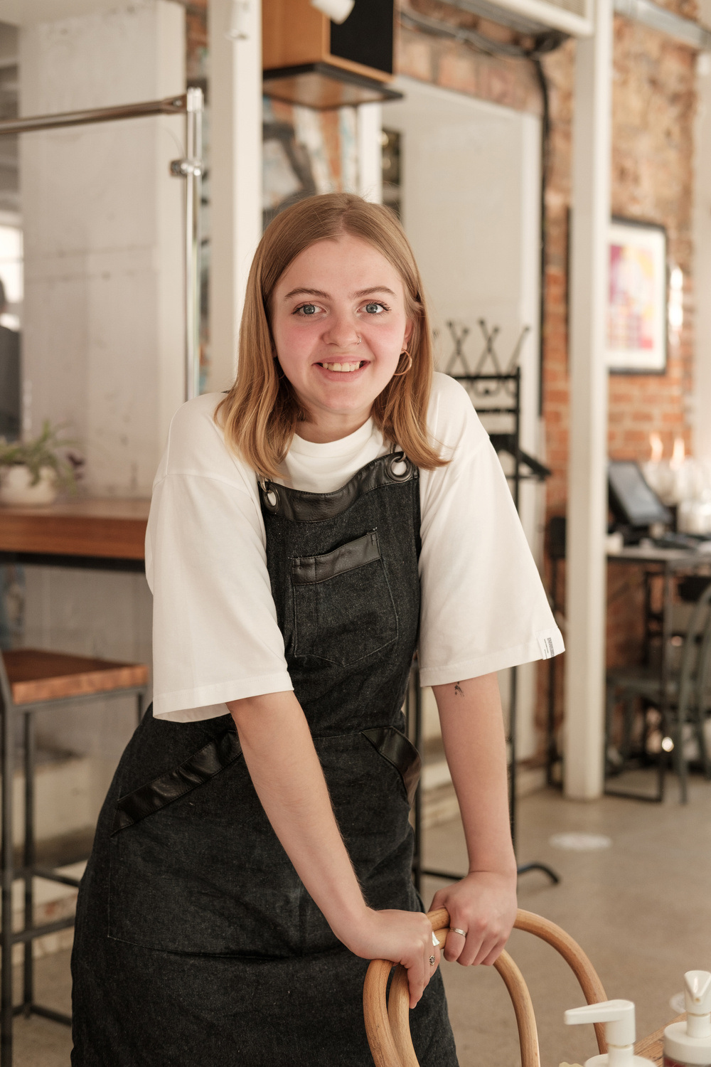 Waitress Standing by a Table in a Restaurant